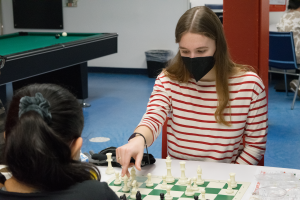 An Amity Program volunteer playing chess