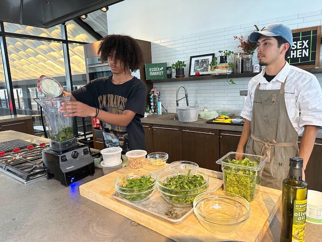 Joseph Sanchez makes pesto using fresh herbs he grew in the Henry Street garden