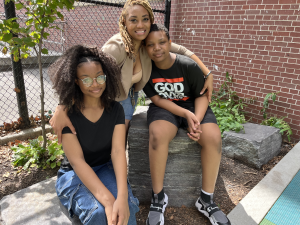 Jennie White wraps her arms around her two children in a neighborhood park