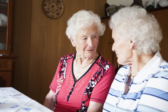 Two seniors look at each other