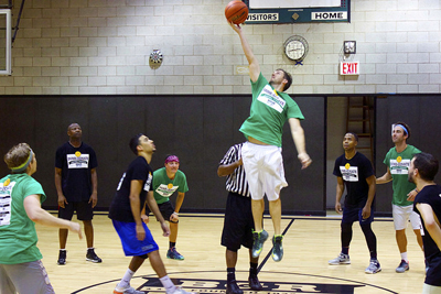 Volunteers play basketball for fundraising event