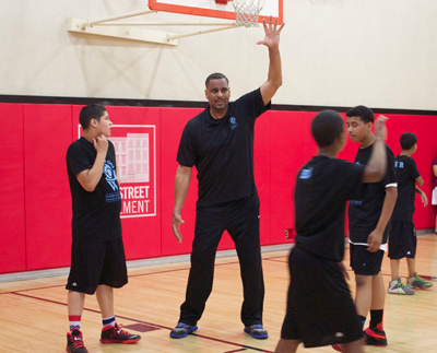 Jayson Williams plays basketball with Henry Street youth
