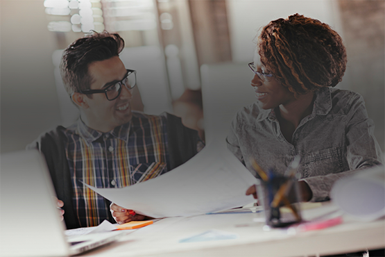 Employees smile at each other (stock photo)