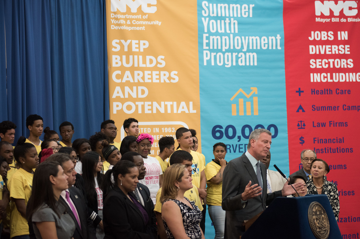 Mayor Bill DeBlasio speaks with youth workers behind him