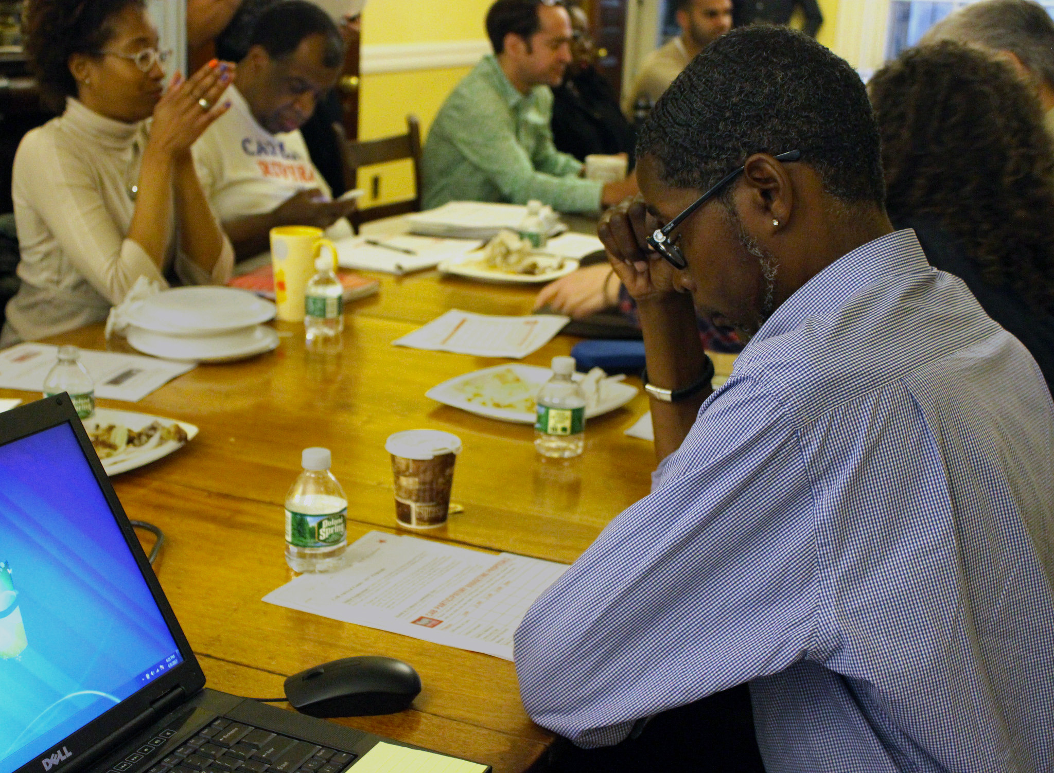 Man looks at paper in meeting