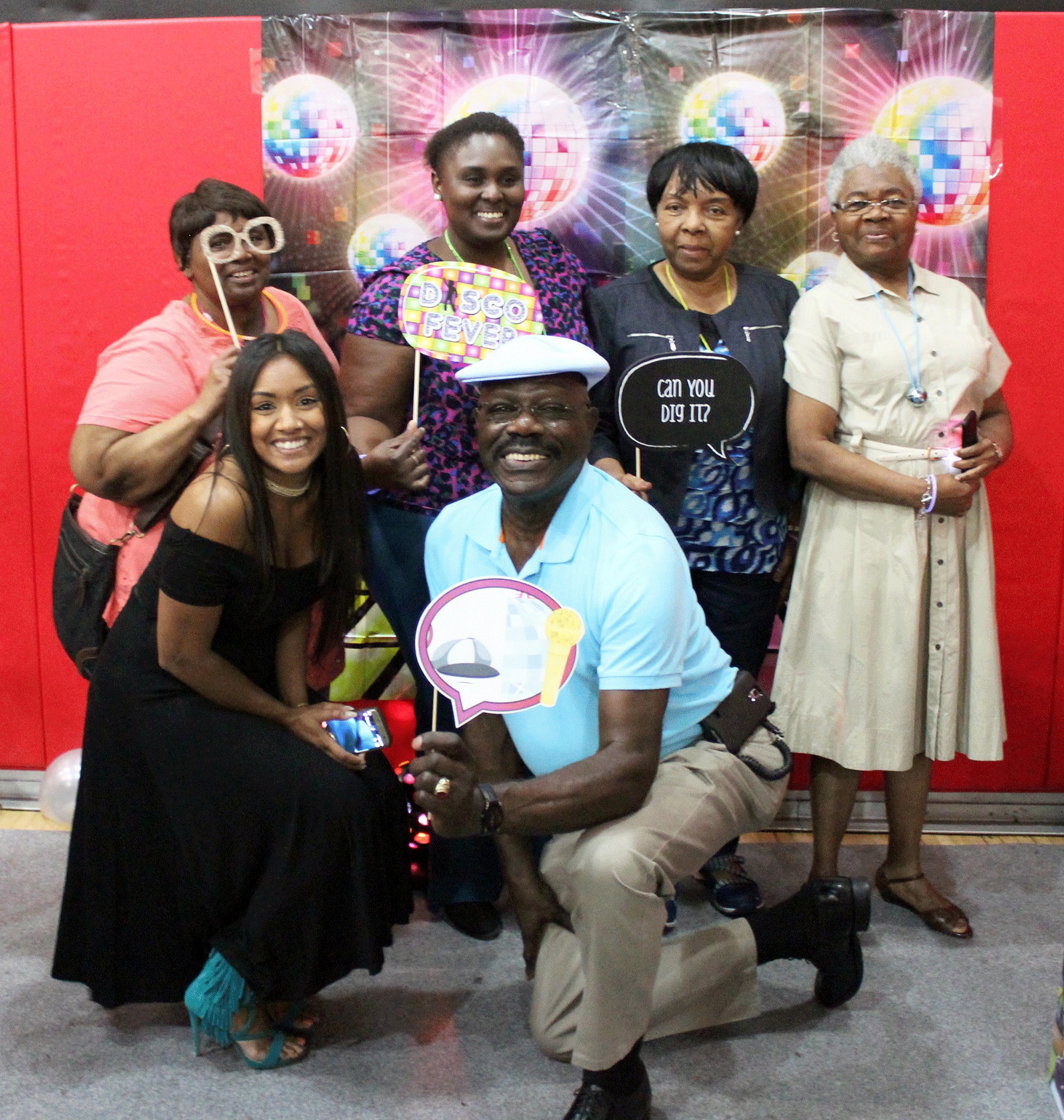 Group smiles at photo booth at event for Senior Companion Program