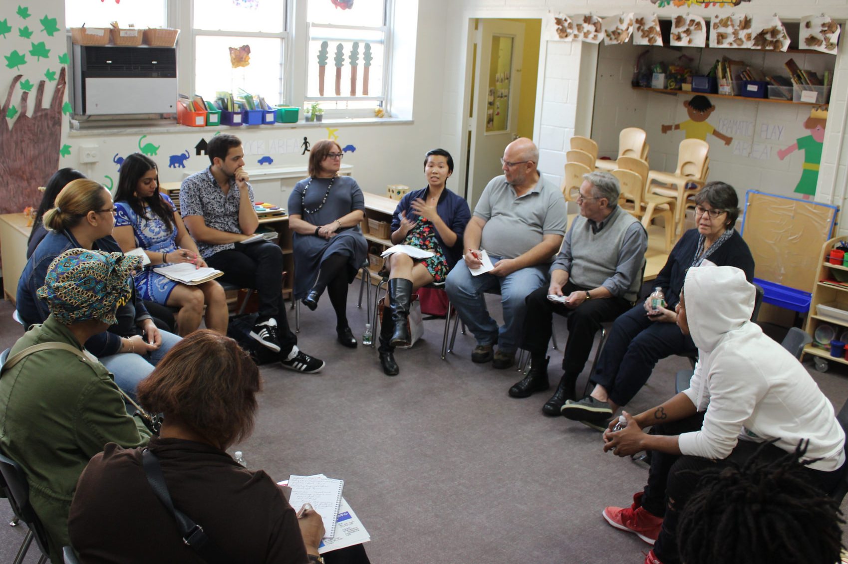 Group discussion as adults sit in circle