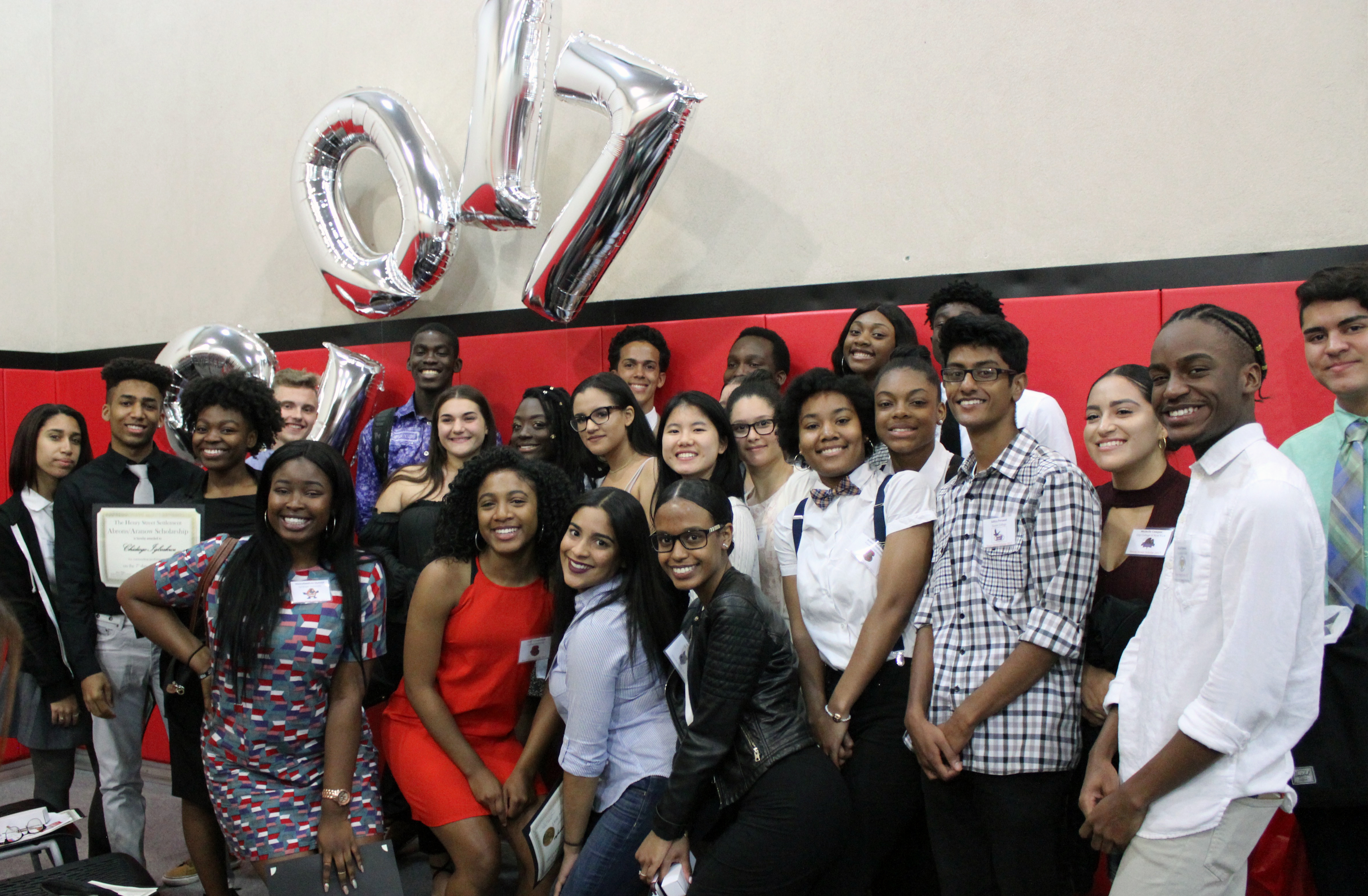 Expanded Horizons youth smile at camera with '2017' balloons