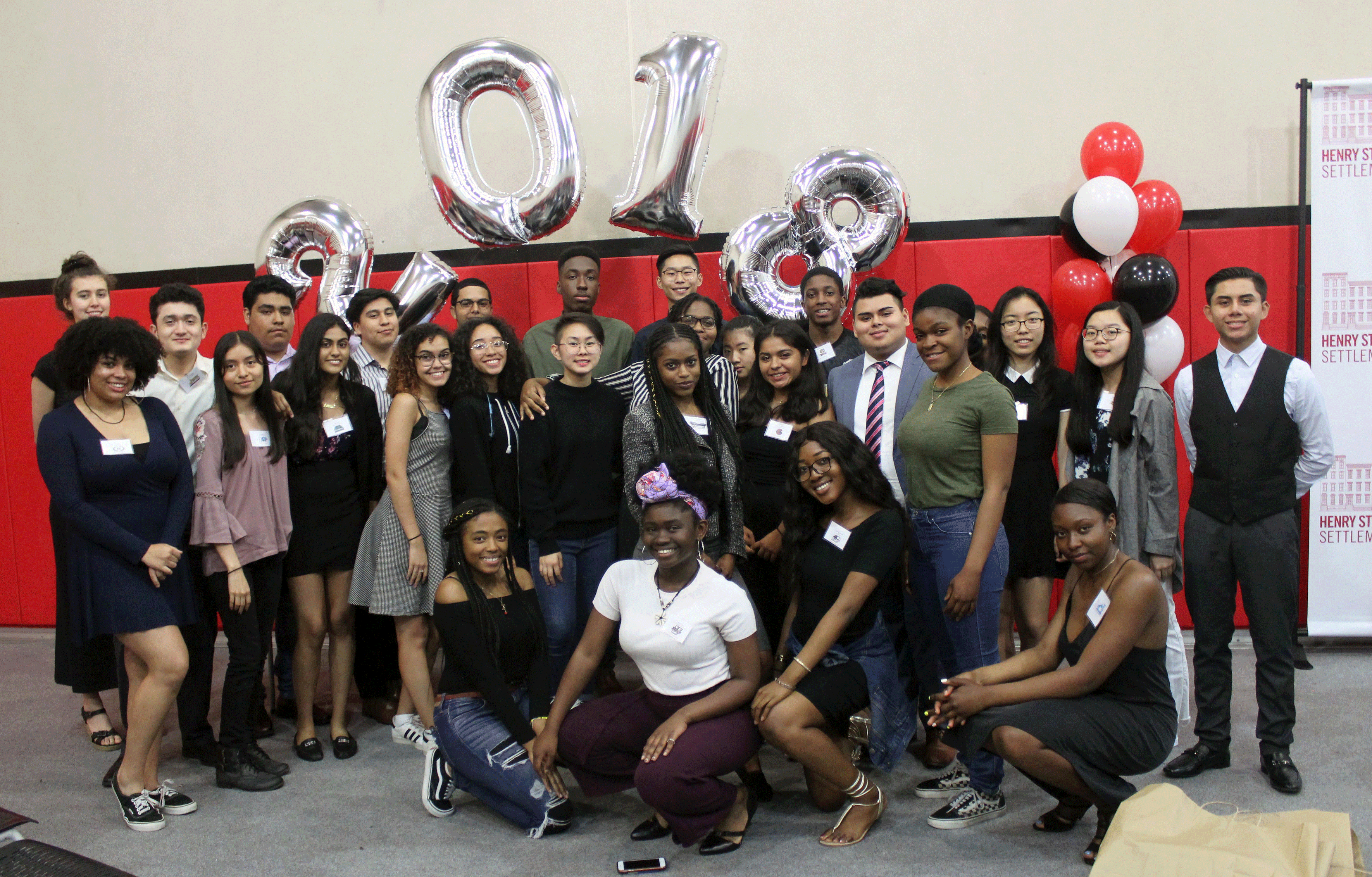 Expanded Horizons youth smile for camera with '2018' balloons