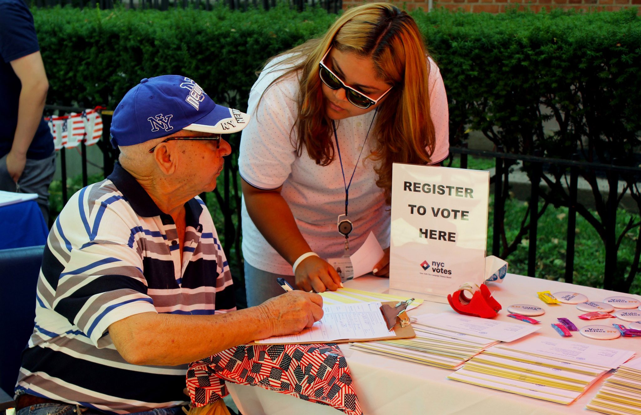 Candid photo of woman helping community member register to vote