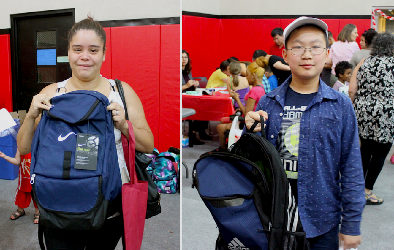 Students holding backpacks and smiling for camera