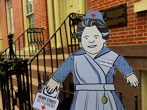 Flat Lillian, a paper doll representation of Henry Street Settlement founder Lillian Wald, outside Henry Street's headquarters