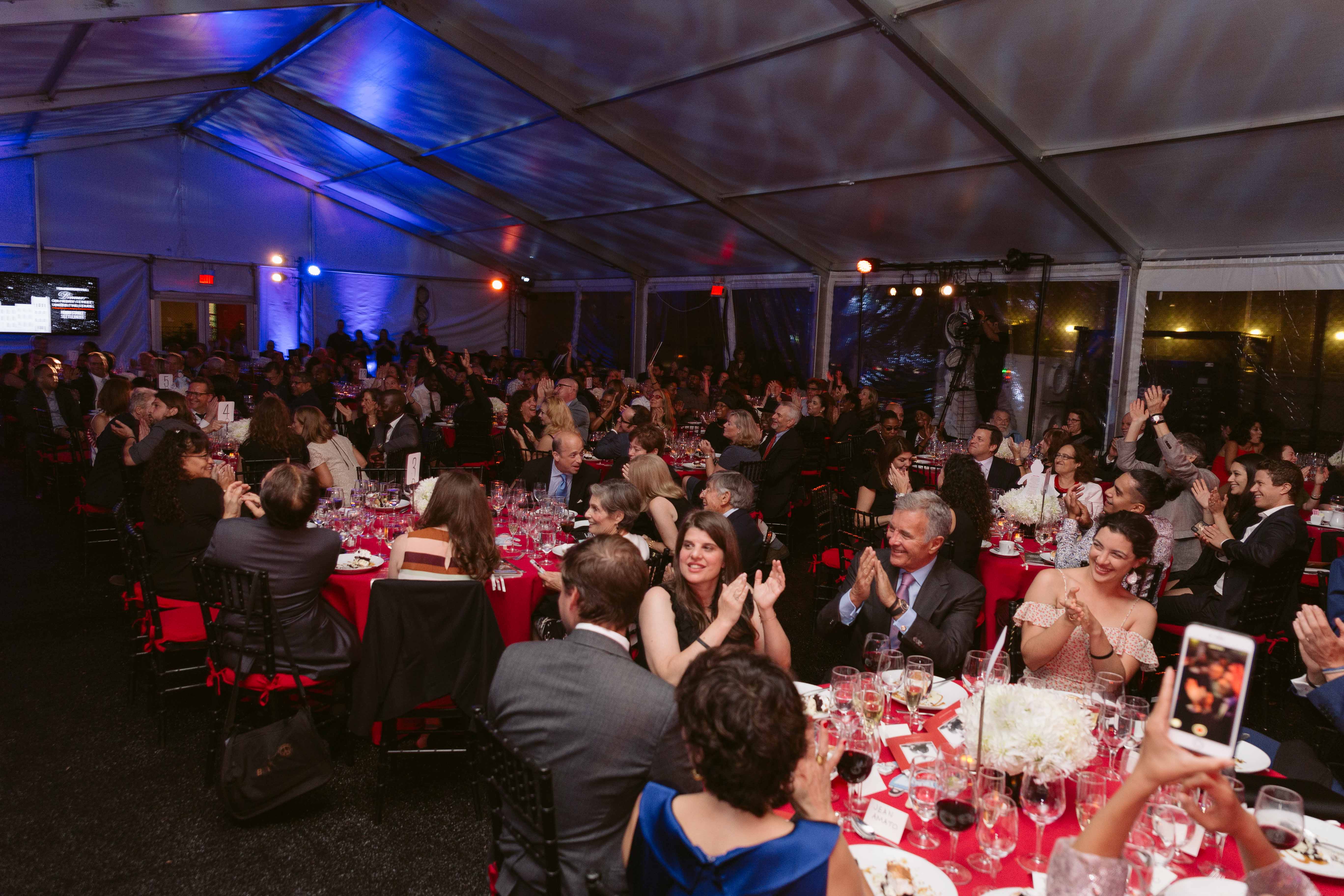 People clap in candid party photo from The Gala on Henry Street