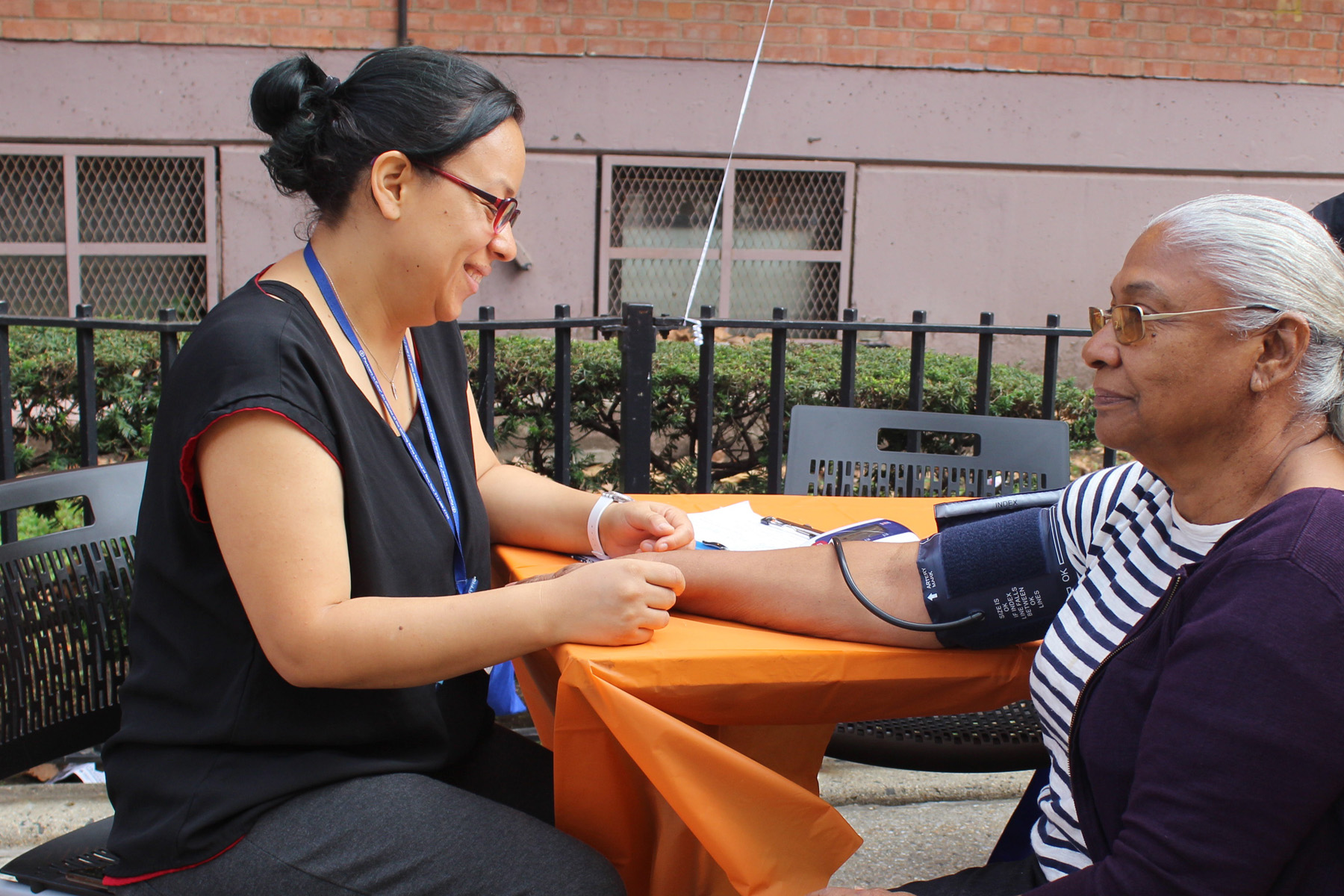 Woman gets her blood pressure taken at outdoor health fair for seniors