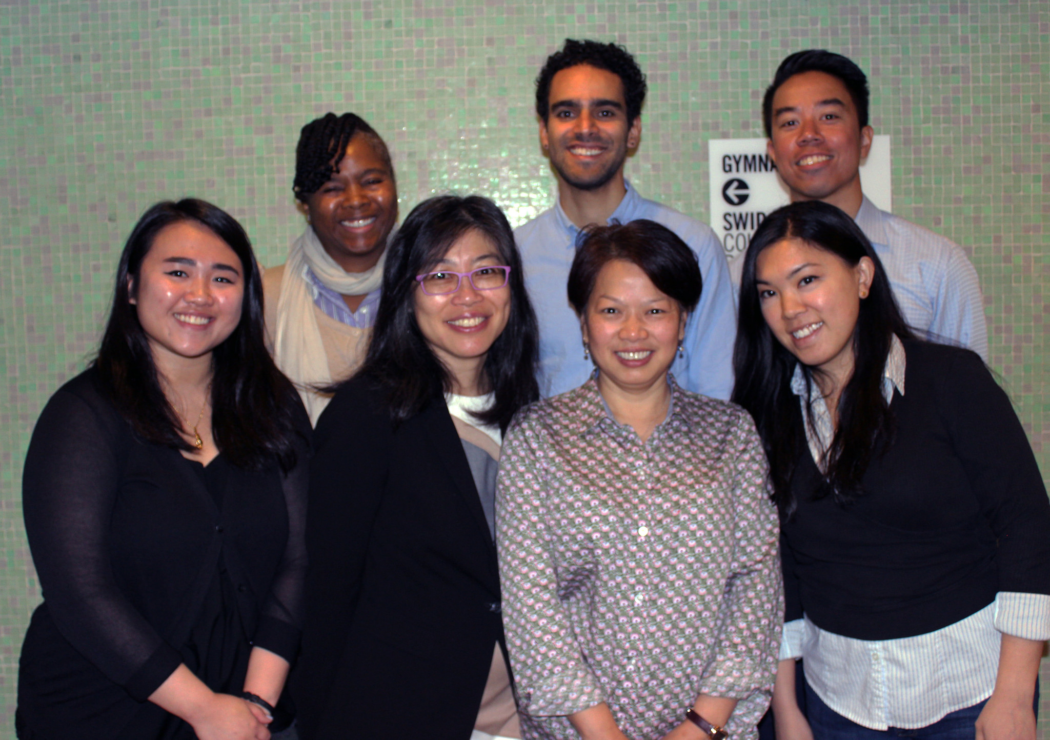 Group staff photo, seven adults smiling at camera