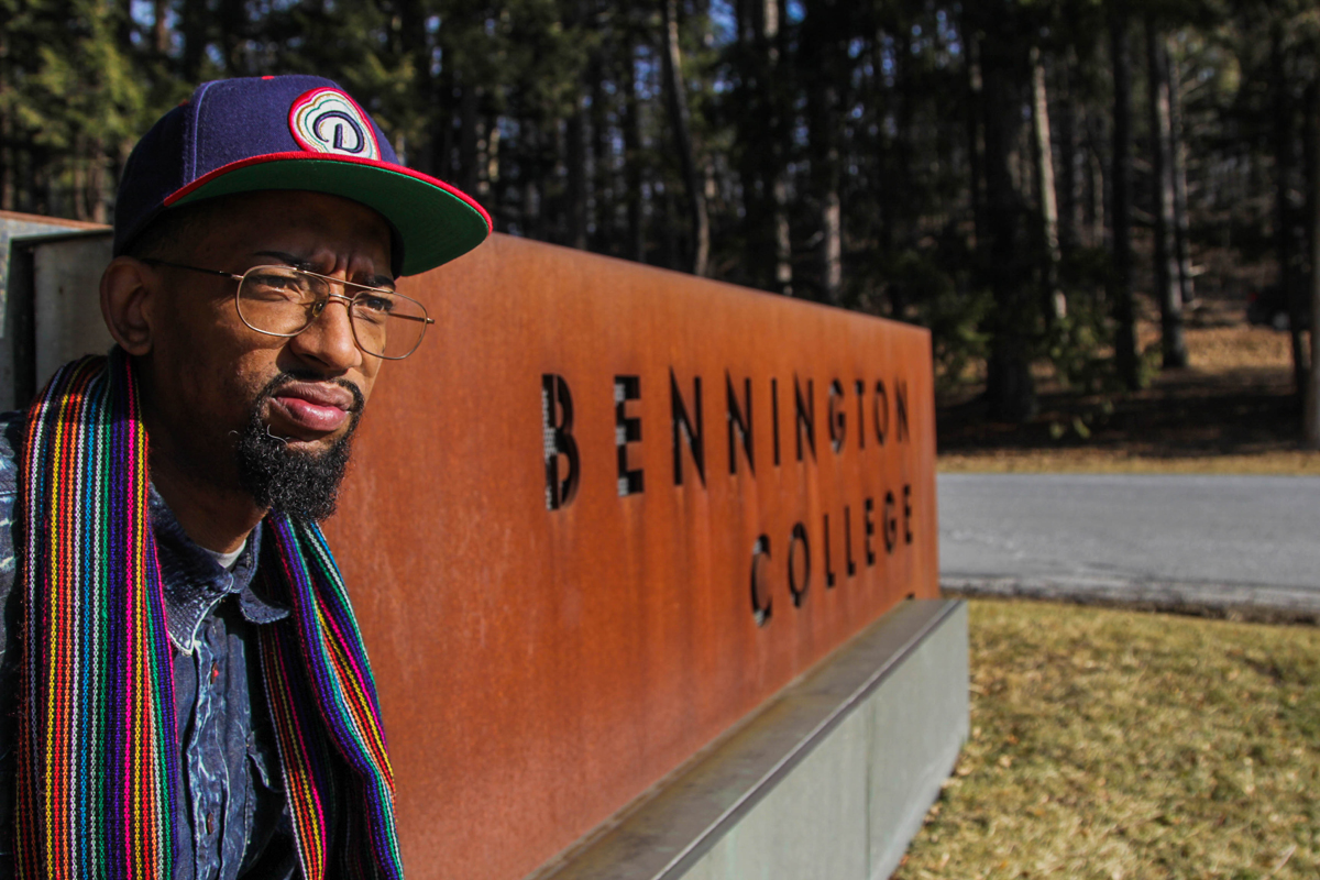 Photo of man in front of Bennington College sign