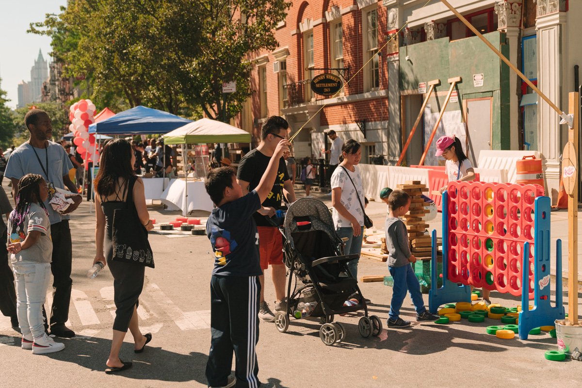 Children playing games on street at outdoor event