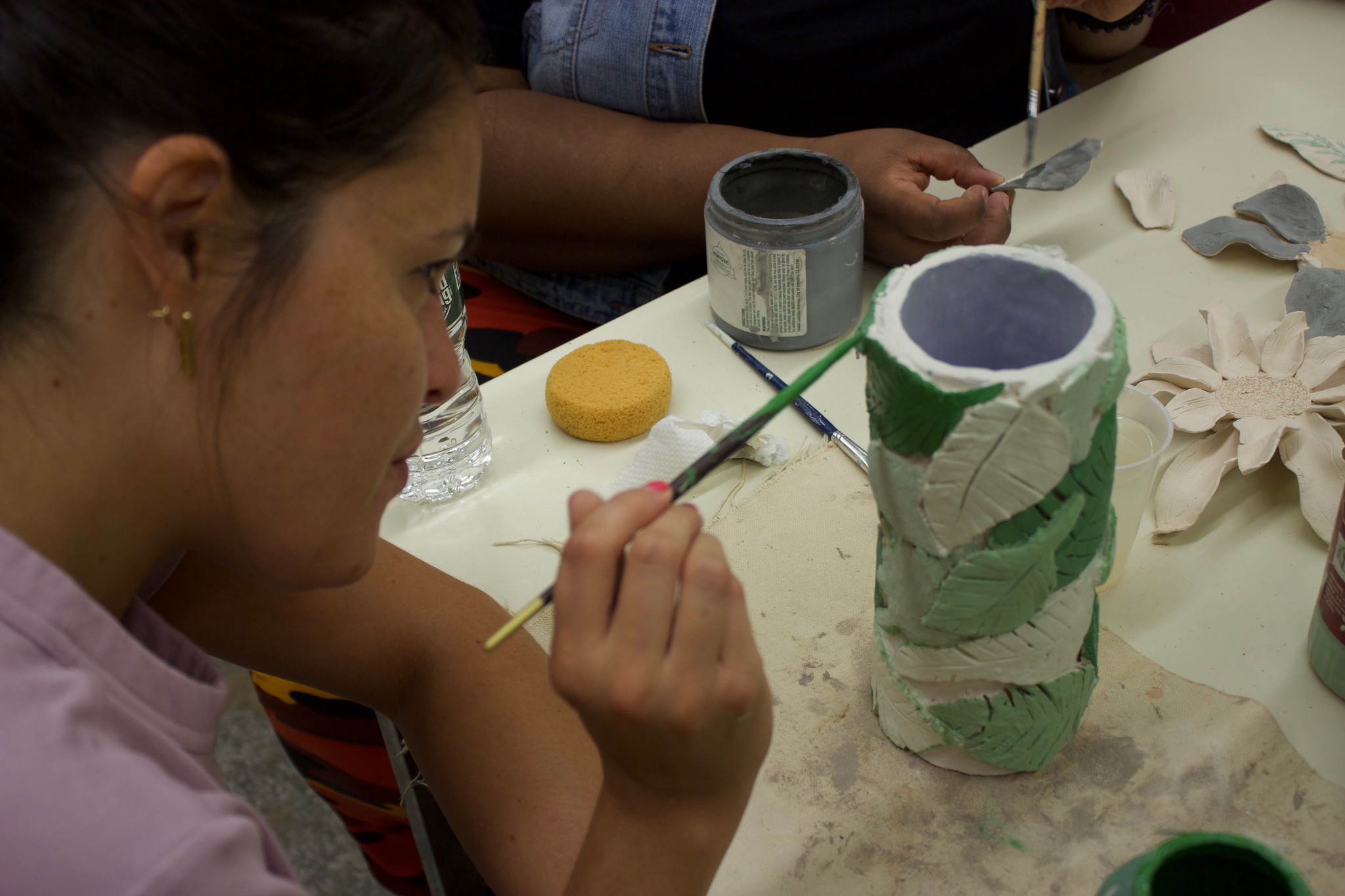CCC Ceramics Gina applying the fishing touches to her leaf vase
