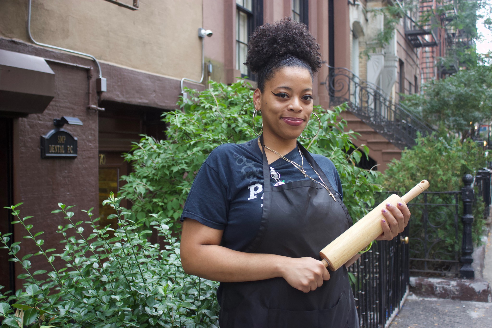 A photo of Kianna Flowers holding a rolling pin.