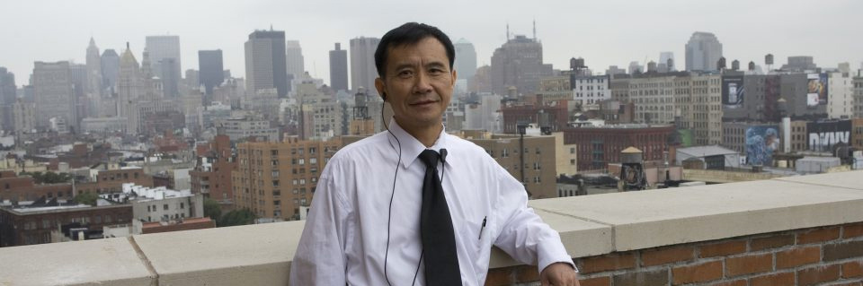 Man in tie in front of cityscape