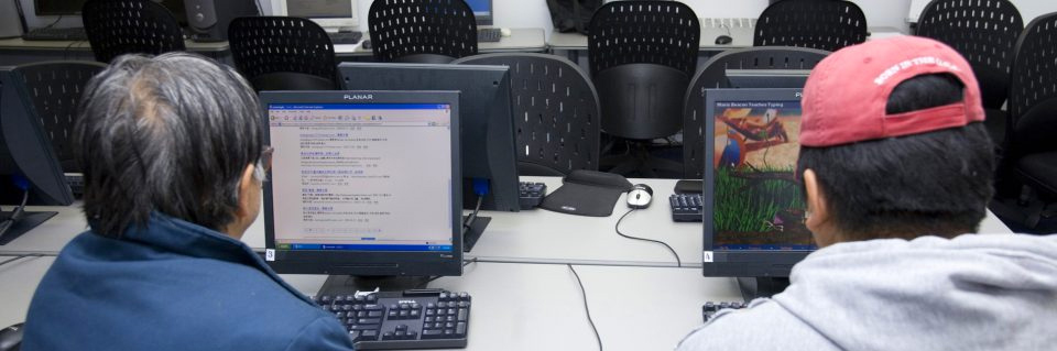 Adults at computers in computer lab