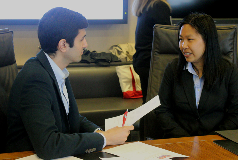 Young man leads mock interview with woman