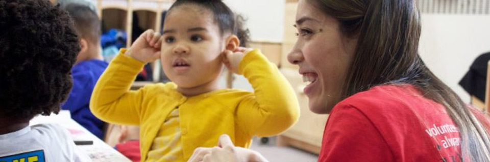 Volunteer smiling with children