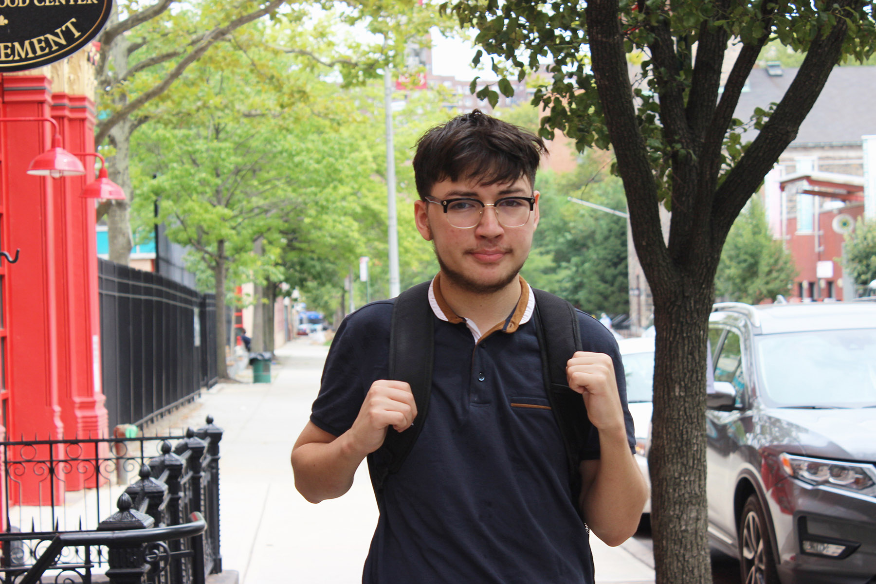 Teen Oscar poses for camera on Henry Street