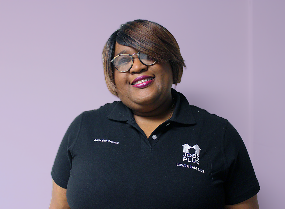 Doris Bell-Francis smiling at the camera, purple background