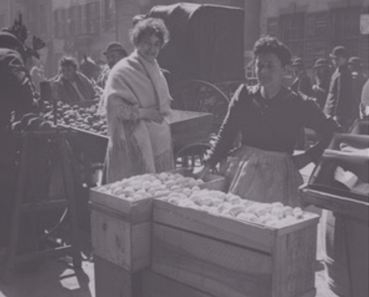 Two women at an open air market on a Lower East Side street, ca. early 1900s