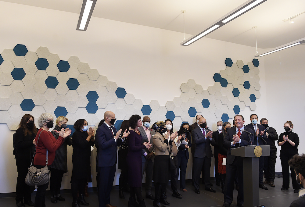 Members of the Mayor's and Comptroller's offices along with nonprofit leaders gather for a press conference.