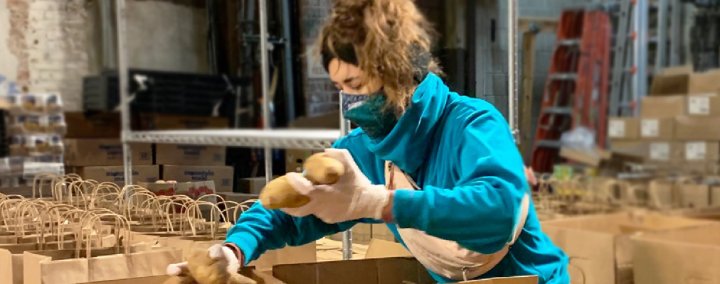 Woman packs boxes of food