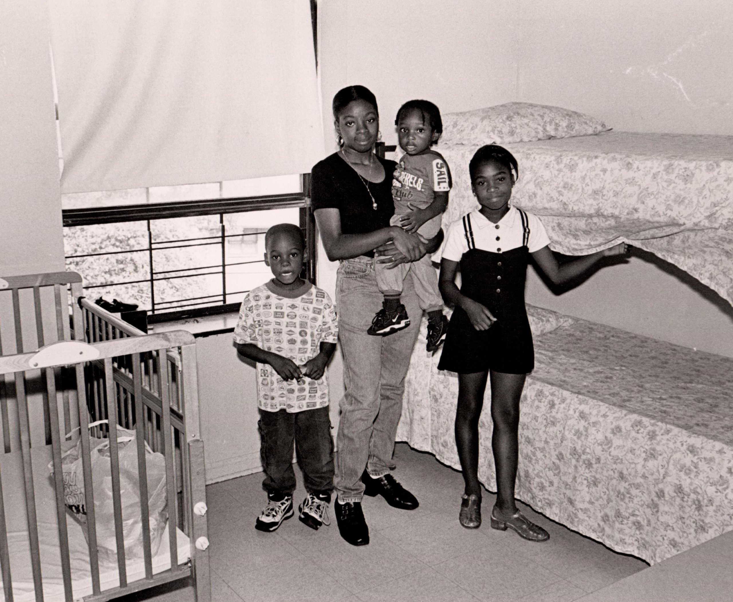 Vintage photo of mother and children in bedroom