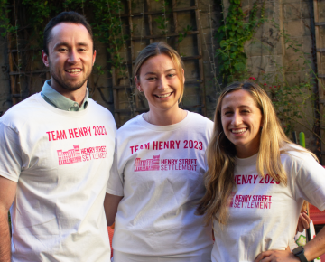 Three members of Henry Street's TCS NYC Marathon charity team pose for a photo at Henry Street headquarters