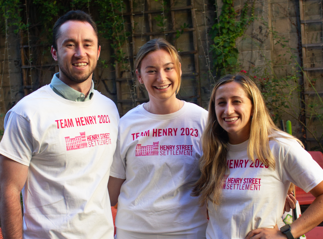 Three members of Henry Street's TCS NYC Marathon charity team pose for a photo at Henry Street headquarters