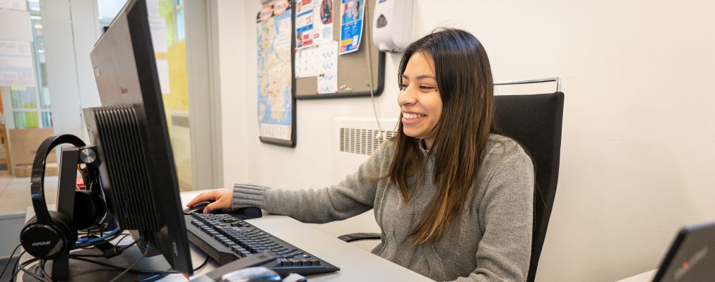 A woman uses a computer in the ATTAIN Lab