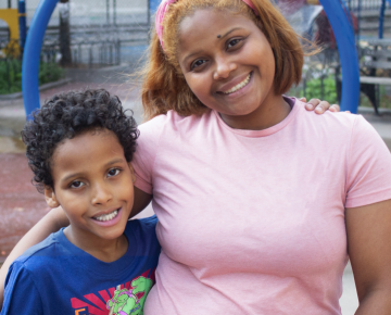 Erick Lopez with his mom in the playground outside his school