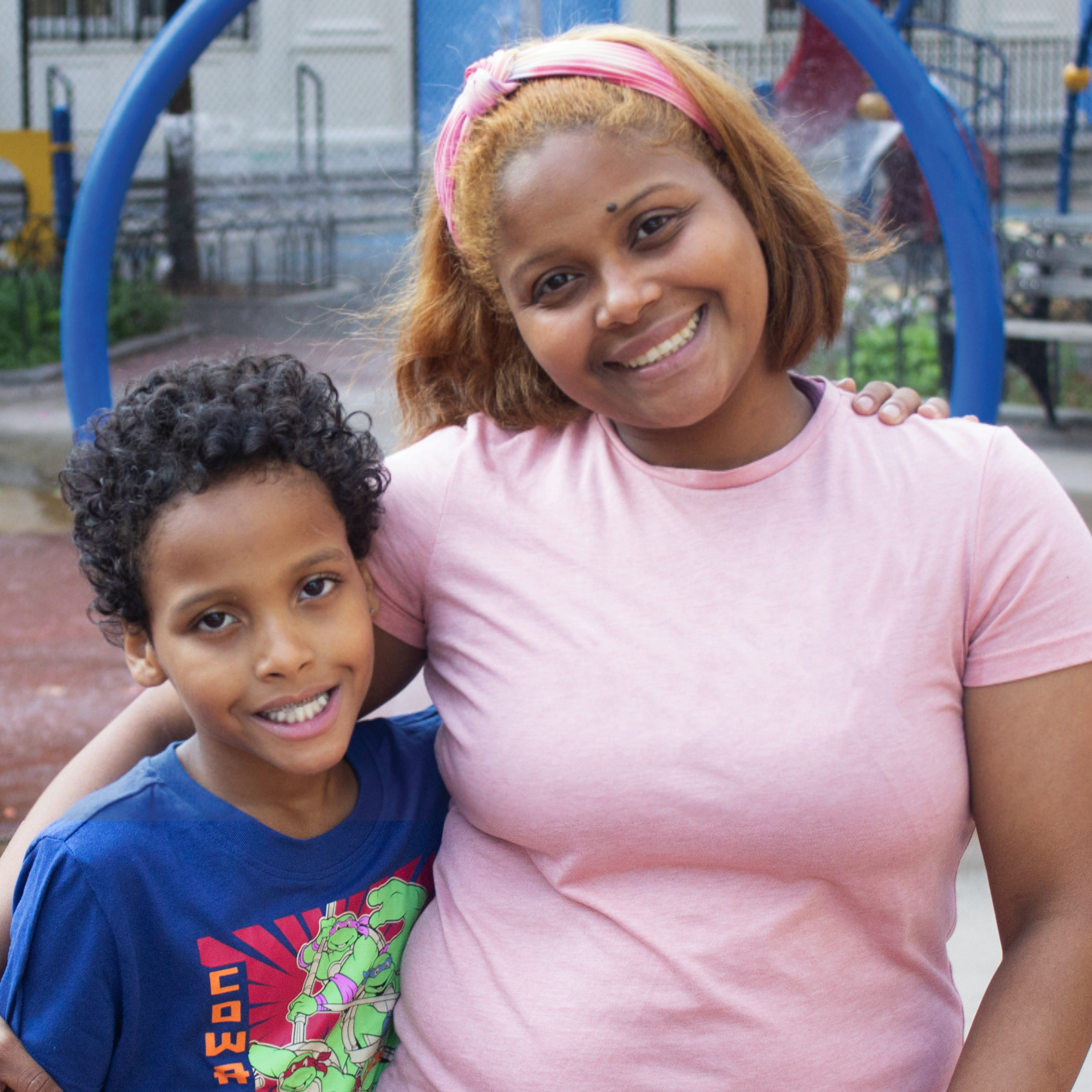 Erick Lopez with his mom in the playground outside his school